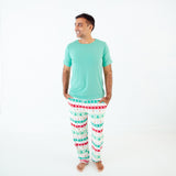 Man wearing holiday themed bamboo pajamas.