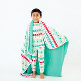 Boy with a faire isle blanket draped.