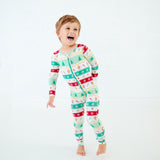 Toddler wearing holiday bamboo convertible footie pajamas.