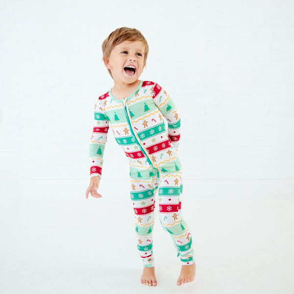 Toddler wearing holiday bamboo convertible footie pajamas.