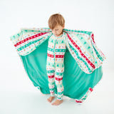 Child wearing a blanket like a cape.