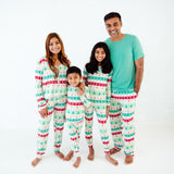 Family of four in matching mint holiday pajamas.