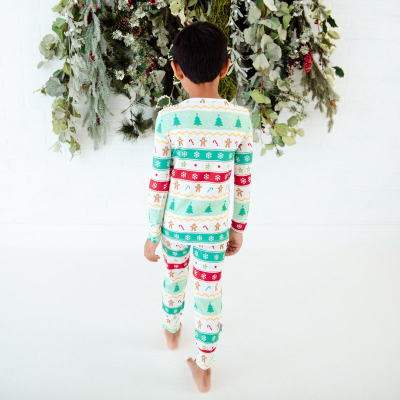 Back view of child in holiday bamboo print pajamas.