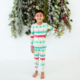 Child wearing mint green holiday bamboo pajamas.