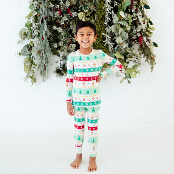 Child wearing mint green holiday bamboo pajamas.