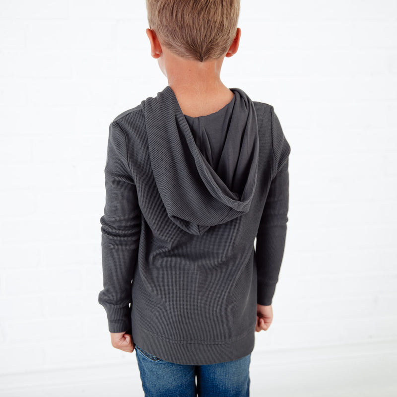 Hood on a boy's grey hoodie. 