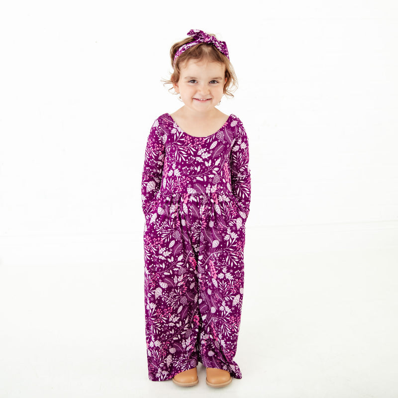 Toddler girl wearing purple floral romper.