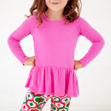 Close-up of a girl in a pink top. 