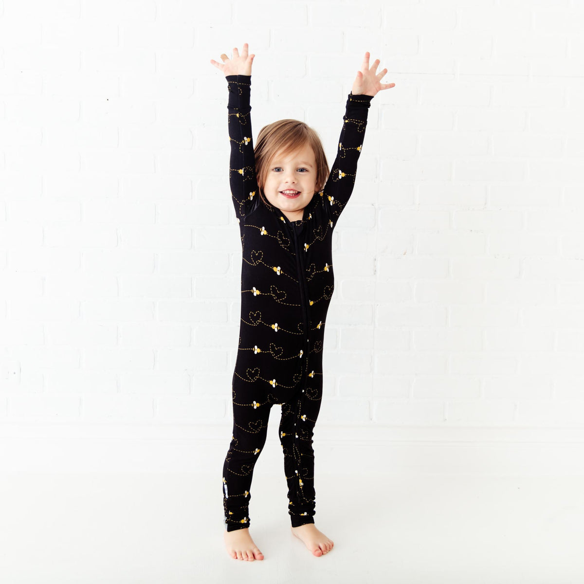 Convertible baby footie with black bees print by Dreamiere