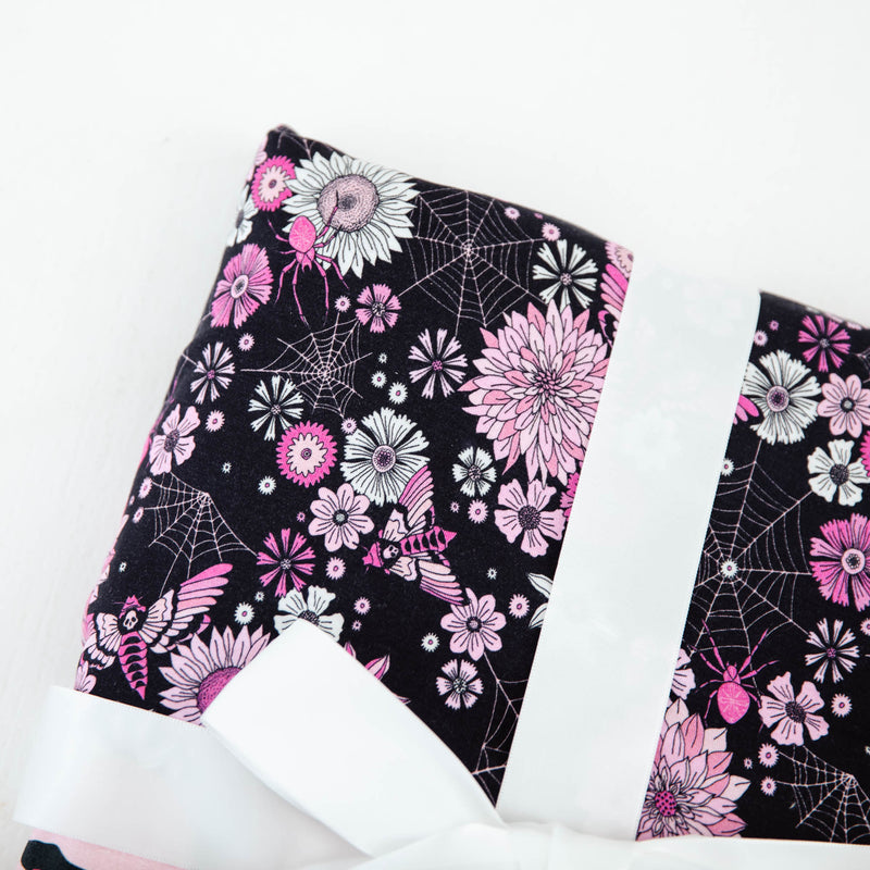 Close-up of black and pink floral blanket.