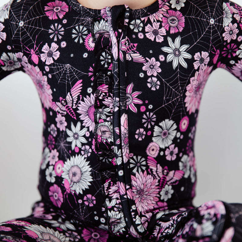 Close-up of spooky Halloween floral zipper pajamas.