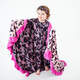Toddler girl wrapped in spooky Halloween blanket. 