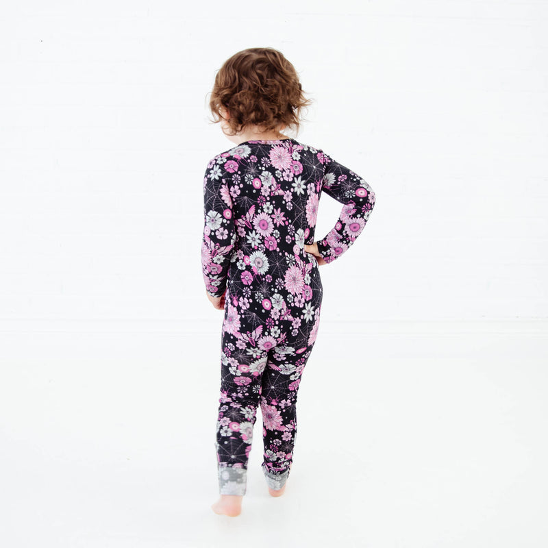 Little girl in floral spooky Halloween pajamas.
