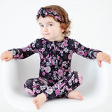 Baby in Halloween spooky floral footie pajamas.