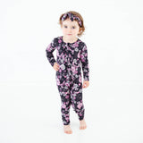 Toddler in spooky Halloween floral zipper pajamas.