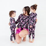 Woman and daughters wearing matching Halloween Pajamas.