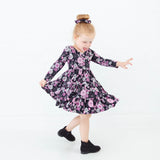 Little girl dancing in a Halloween Dress.