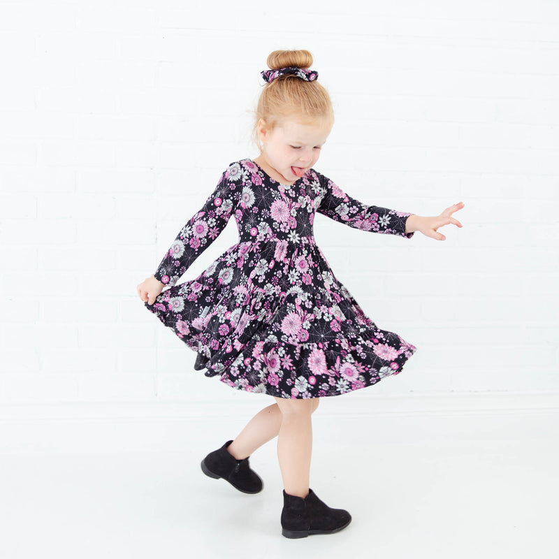 Little girl dancing in a Halloween Dress.
