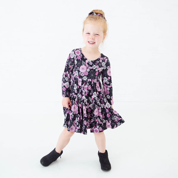 Young girl wearing a Halloween swing dress.