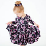 Girl looking at her spooky floral dress.