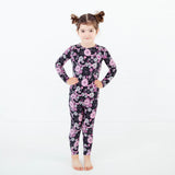 Girl wearing a spooky floral pajamas set.