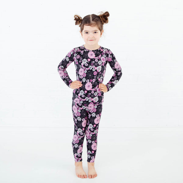 Girl wearing a spooky floral pajamas set.