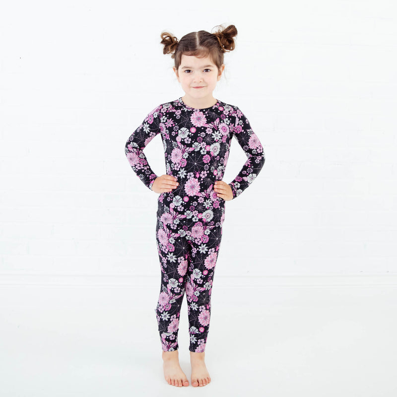 Girl wearing a spooky floral pajamas set.