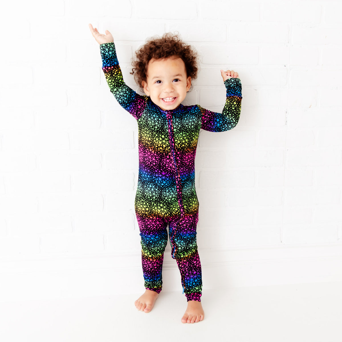 Baby footie with black background and star pattern by Dreamiere