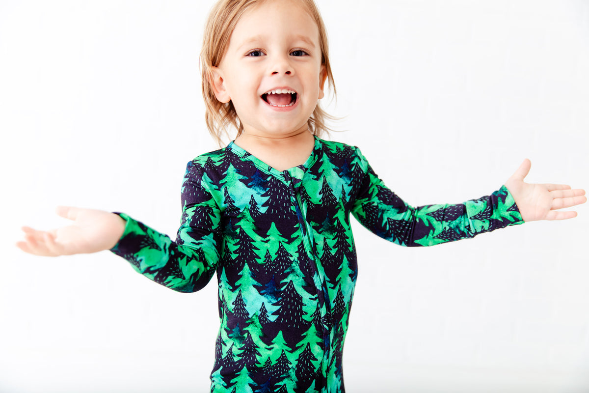 Convertible baby footie with black trees and green flecks by Dreamiere