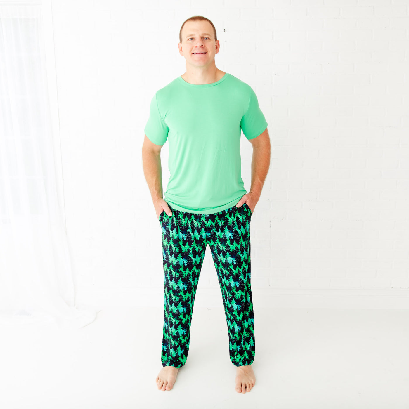Men's loungewear with black tree and green fleck pattern by Dreamiere