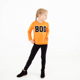 Girl wearing Orange BOO sweatshirt. 