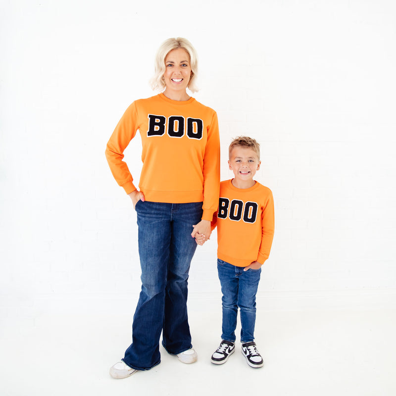 Mom and son matching in BOO sweatshirts. 