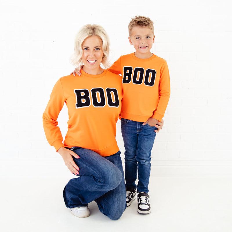 Mom and son in matching BOO shirts. 