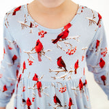 Light blue dress with red cardinal bird pattern.