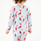 Child wearing winter cardinal scene pjs.
