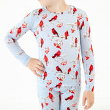 Close-up of a winter scene with cardinals on kids pajamas.