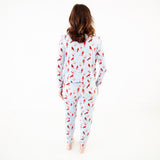 Woman wearing a cardinal pajama set.