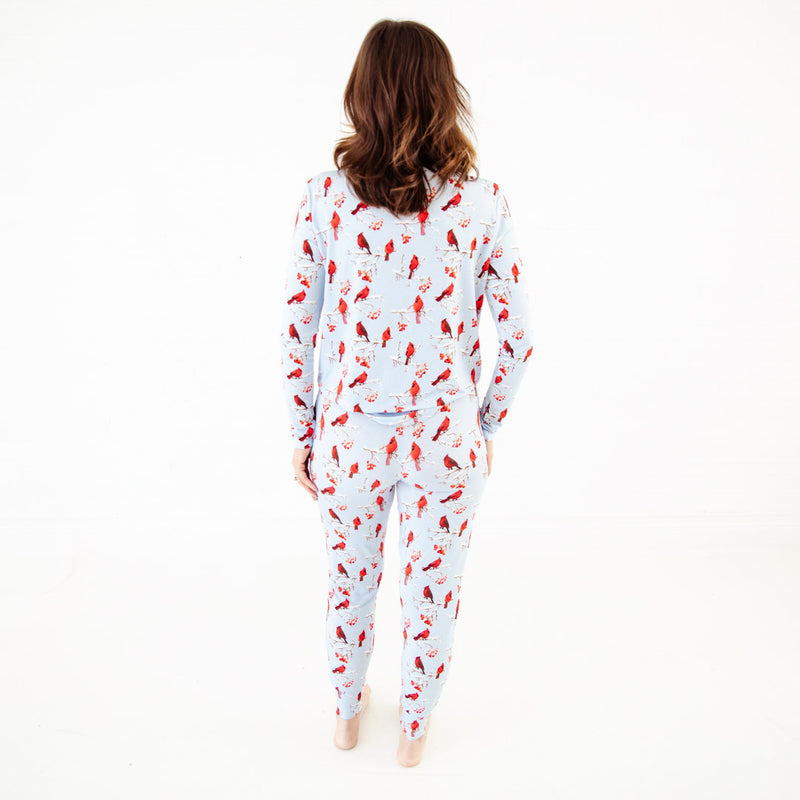 Woman wearing a cardinal pajama set.