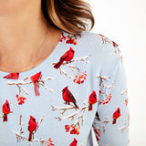 Light blue shirt with red cardinal bird pattern.