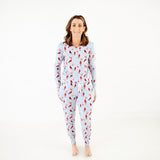 Woman wearing blue pajamas with cardinals. 