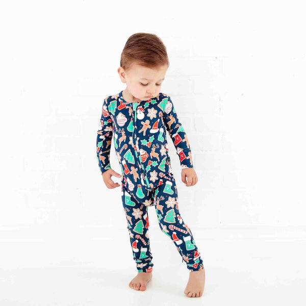 Boy in Navy Christmas Themed Zipper Pajamas.