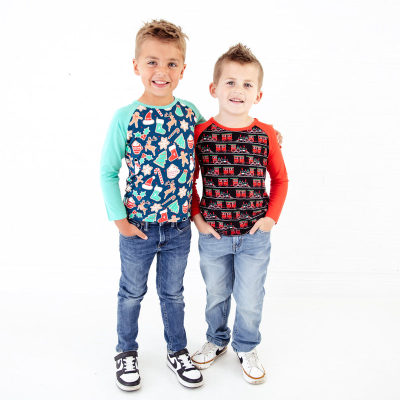 Two young boys in Christmas themed shirts.