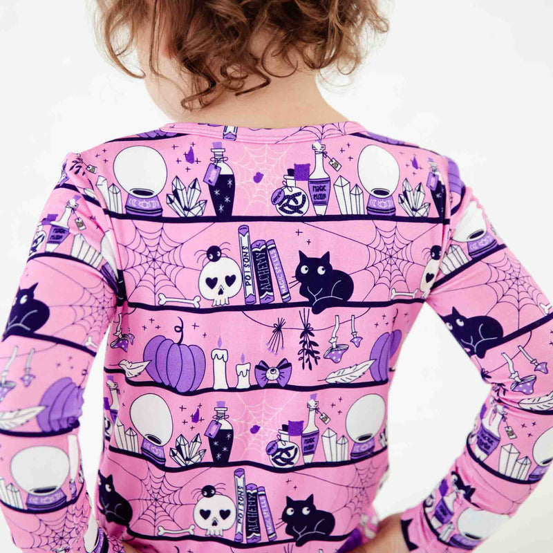A Pink and purple halloween pajama print. 