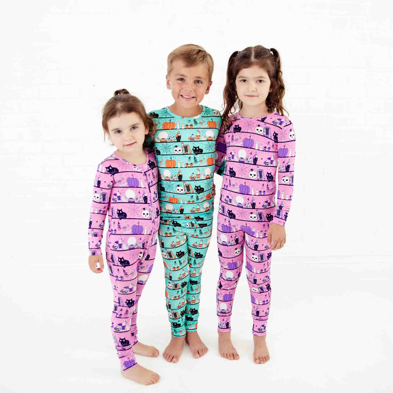 Group of kids wearing coordinating halloween pajamas. 