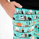 Hand in the pocket of men's Halloween pajama pants. 