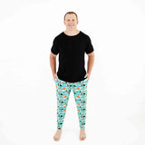 Man wearing teal Halloween themed pajamas. 