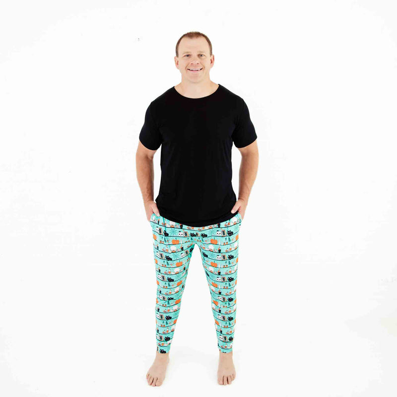Man wearing teal Halloween themed pajamas. 