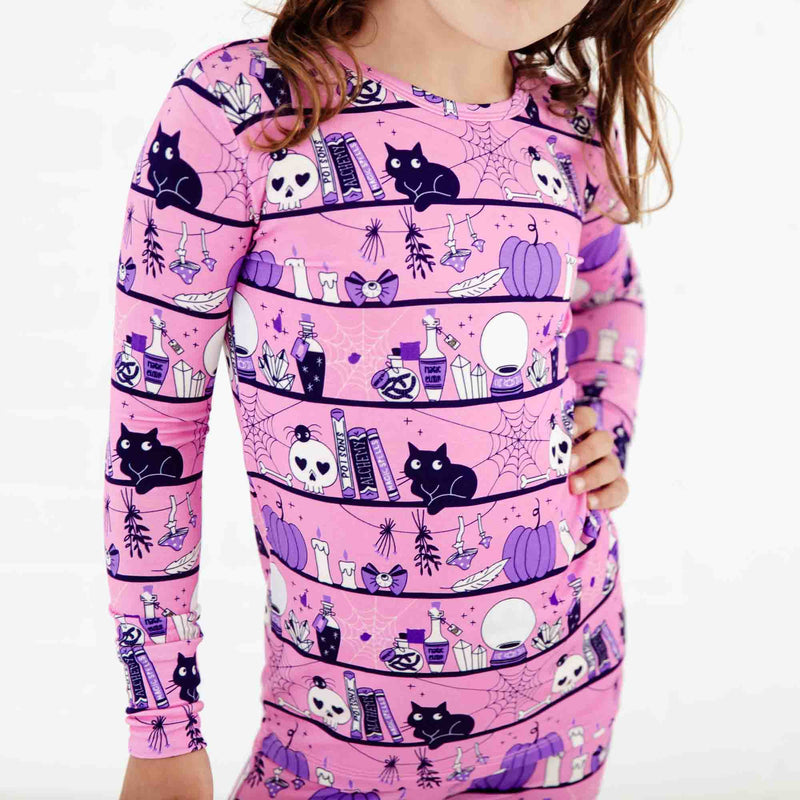 Pink Halloween pajamas with cats and spiders. 