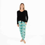 Woman wearing black and teal Halloween pajamas. 