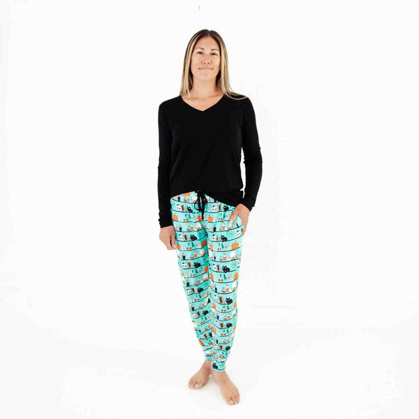 Woman wearing black and teal Halloween pajamas. 